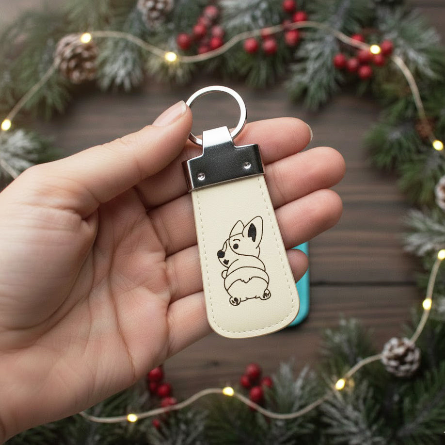 Hand holding a custom engraved leather keychain in honey brown leather with a paw print and name engraving, showcasing premium craftsmanship and personalized details. Perfect as a pet owner gift, dog mom or dog dad accessory, birthday gift, Christmas stocking stuffer, or meaningful everyday keychain. Full-grain leather and customizable engraving make it a durable, thoughtful keepsake.