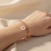 Model wearing stylish rose gold plated paw print disc bangle. Perfect memorial keepsake for any dog mom cat mom. 