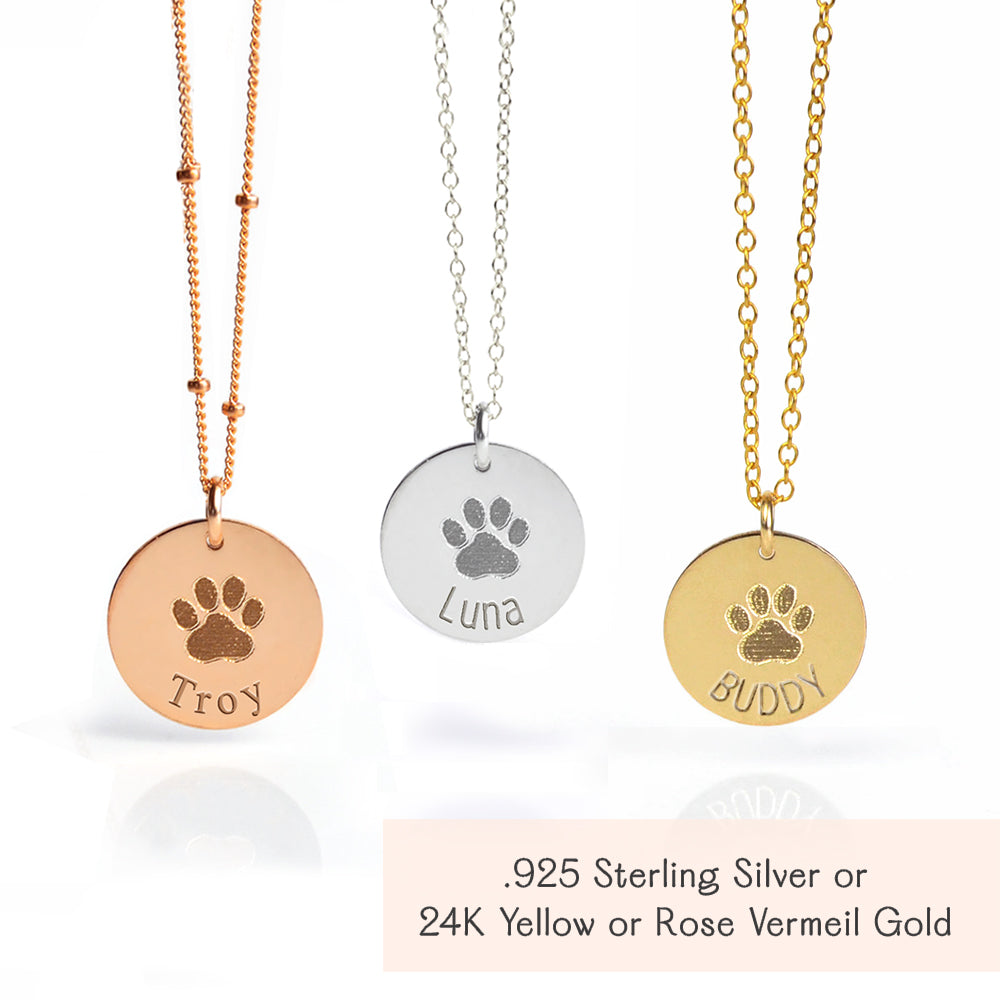 Sterling silver, gold-filled, and rose gold-filled engraved disc necklaces, each personalized with an actual paw print and pet name, custom pet memorial jewelry keepsakes for honoring the memory of beloved pets.