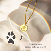 Custom actual paw print engraving on a gold disc pendant necklace, shown alongside a printed paw print for comparison, personalized pet keepsake jewelry, perfect memorial gift for dog or cat lovers.
