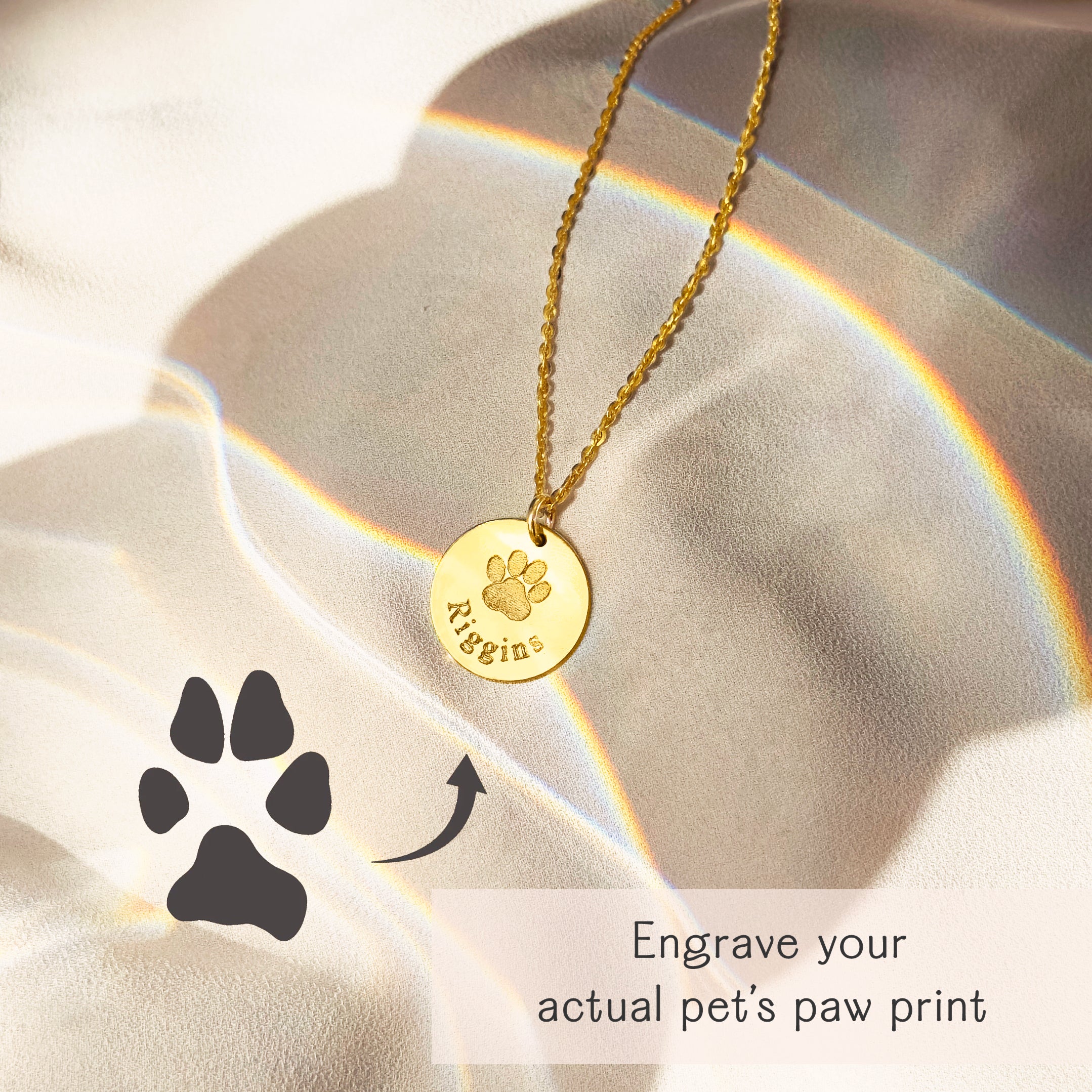 Custom actual paw print engraving on a gold disc pendant necklace, shown alongside a printed paw print for comparison, personalized pet keepsake jewelry, perfect memorial gift for dog or cat lovers.