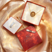 Personalized pet jewelry gift set from Danique Jewelry featuring custom dog nose ring in sterling silver, engraved disc pendant necklace with paw print and pet’s name, and gold filled nameplate bar pendant bracelet with paw print engraving. Unique pet memorial and keepsake jewelry for dog moms, cat lovers, and pet owners. Handmade and custom engraved, perfect for birthdays, anniversaries, remembrance gifts. Beautifully packaged in red Danique Jewelry gift boxes, available in rose gold or silver.