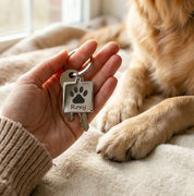 Personalized dog paw print keychain displayed beside a resting dog paw, emphasizing emotional connection and remembrance. This custom pet paw print keychain is engraved with your dog’s name, making it a heartfelt memorial keychain or thoughtful pet loss gift. Perfect for dog lovers seeking a meaningful keepsake, everyday dog keychain, or remembrance accessory crafted with care and precision.