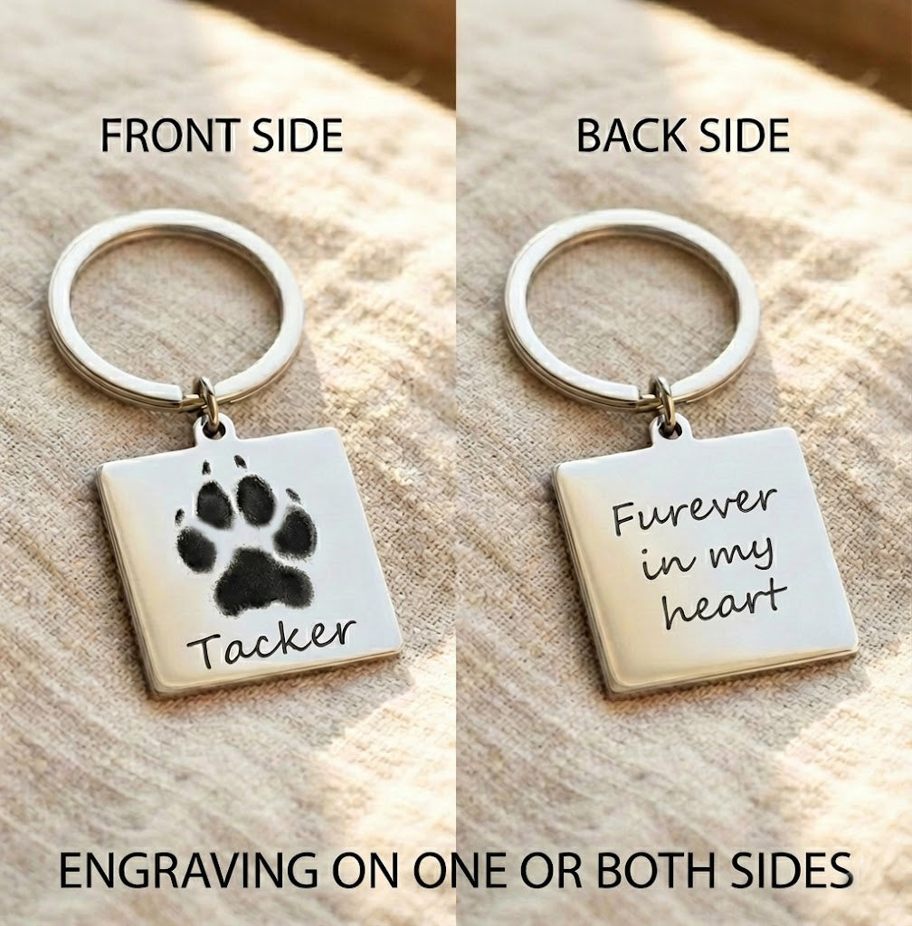 Personalized pet paw print keychain showing front and back engraving options, featuring a square stainless steel charm engraved with a dog paw print and pet name on the front and a custom message reading “Forever in my heart” on the back, attached to a durable silver keyring, custom pet memorial keychain gift for dog lovers, cat owners, pet parents, remembrance keepsake, handmade personalized pet loss gift, sympathy gift for pet owners, meaningful everyday accessory