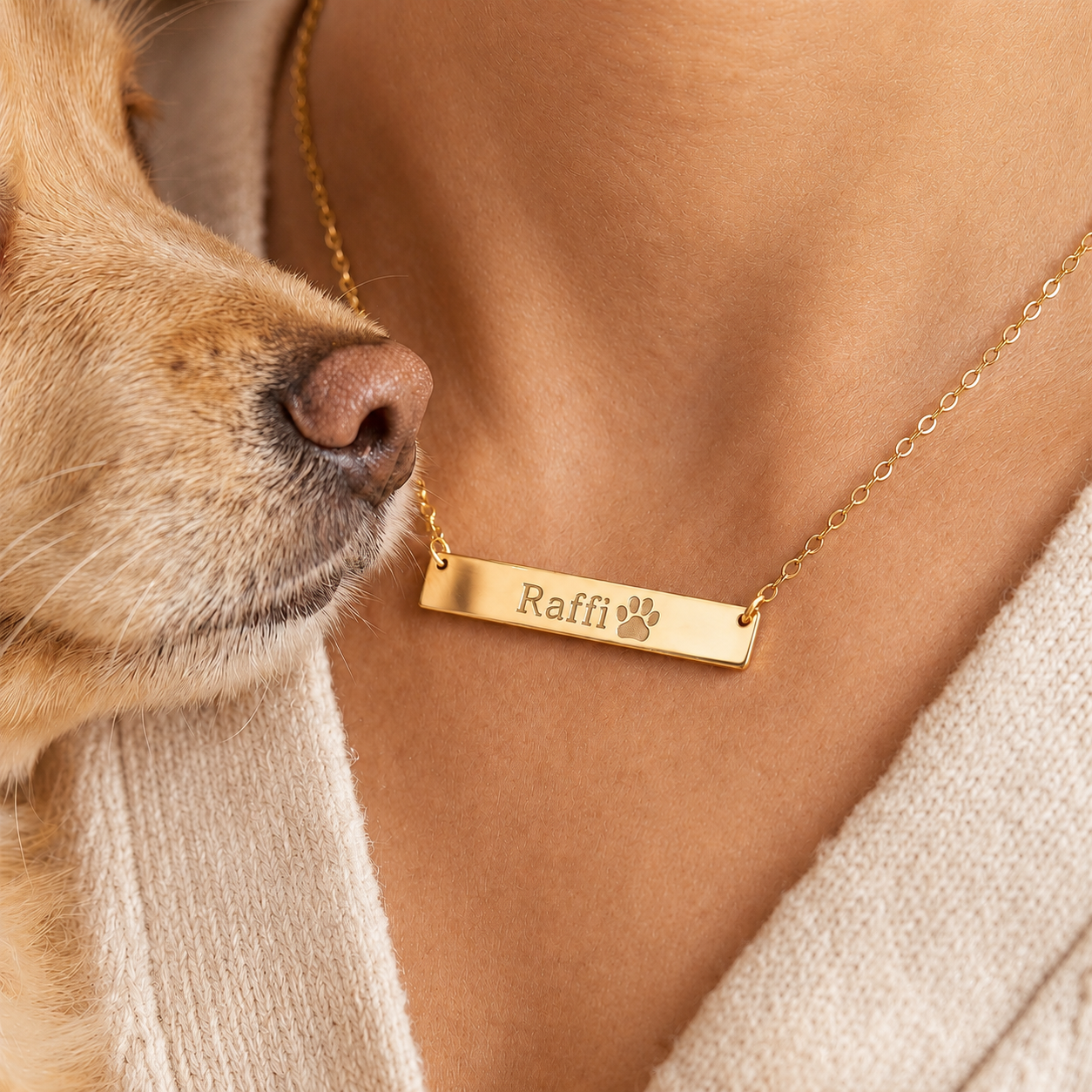 Gold bar paw print necklace with engraved paw print and name "Raffi" in modern font. Personalized pet jewelry made from actual pet paw print, ideal gift for pet lovers, dog moms, and cat owners. Custom gold-filled pendant necklace for birthdays, memorial keepsake, or everyday wear. Includes elegant chain, premium finish, and ready-to-gift packaging.