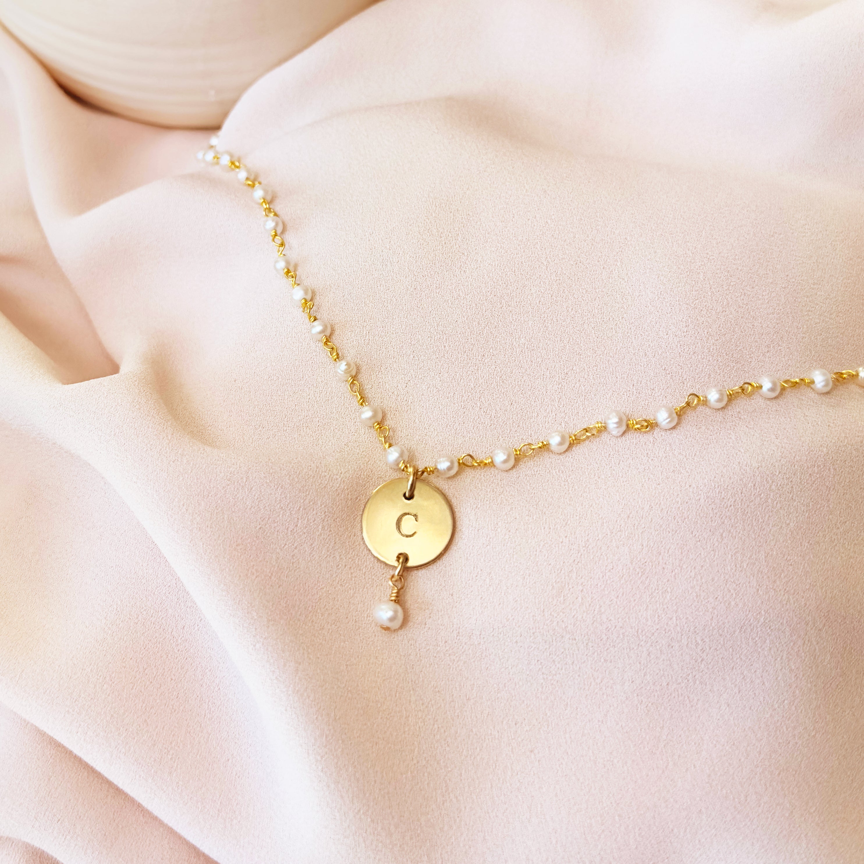 Gold wire wrapped pearl bracelet with disc engraved with the letter C  with dangling pearl on a white background. Dangling pearl charm optional. Nature inspired jewelry, gift for mom nature bracelet, dainty bracelet, charm bracelet