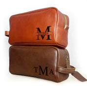 Personalized men’s leather toiletry bags in cinnamon and espresso brown, engraved with monograms and initials, ideal as custom engraved dopp kits for groomsmen, anniversary gifts, or Father’s Day presents. Classic handmade leather design with durable zipper and travel-friendly handle.
