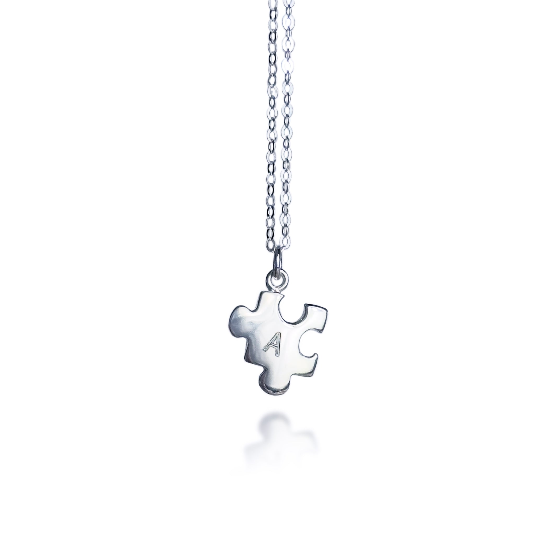 Silver puzzle charm necklace with A initial on white background. sterling silver or vermeil gold, each charm features a single engraved initial. Whether it’s for your other half, your lifelong best friend, or a bond between mother and child, this necklace makes a meaningful gift for Christmas, Mother’s Day, or Valentine’s Day. layering necklace, puzzle piece, bff jewelry, couples jewelry, bff necklace, couples necklace
