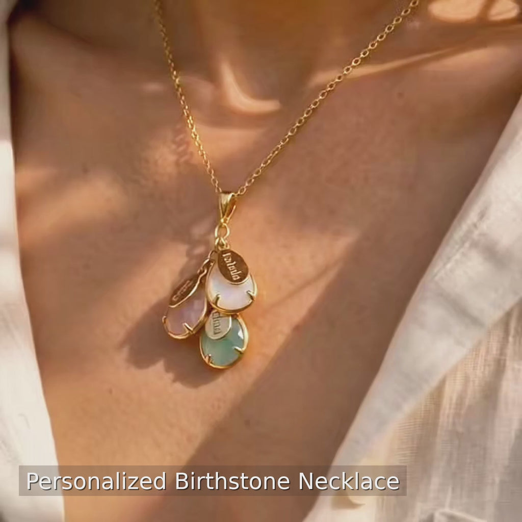 A video showcasing a personalized birthstone necklace and earrings set for mom with teardrop gemstones and engraved name charms family jewelry