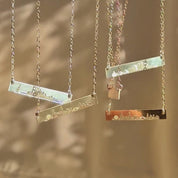 Video showcasing custom skyline bar necklaces in rose gold filled, yellow gold filled, and sterling silver, featuring engraved city skyline designs on dainty bar pendants; personalized travel jewelry, meaningful city necklace gift for her, bridesmaids, graduation, or long-distance friendship.
