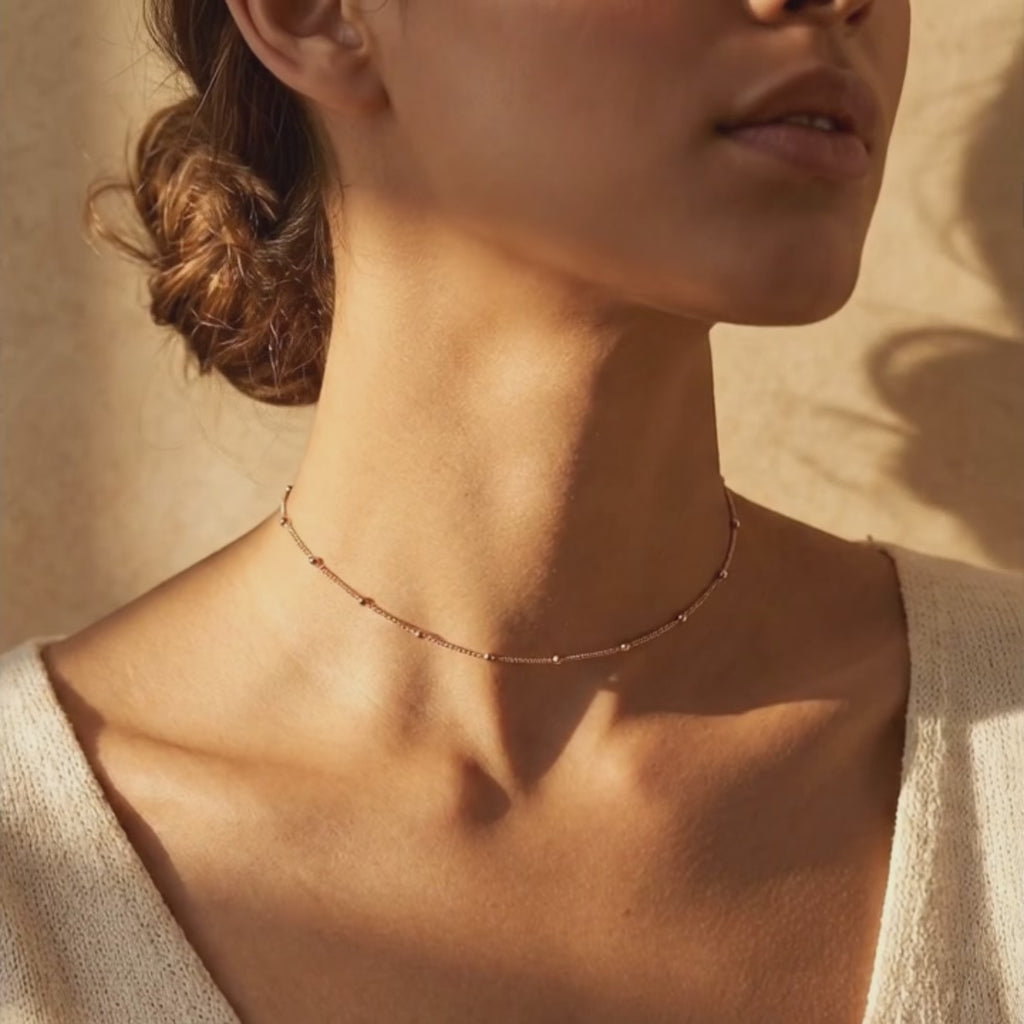 Product video showcasing delicate satellite chain choker necklace, minimalist gold layering necklace for women, dainty everyday jewelry with modern lightweight design