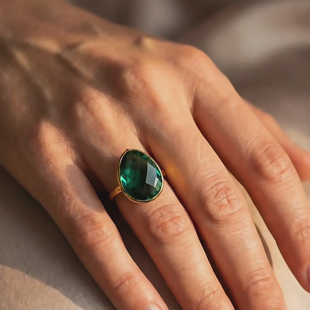 bold oval green tourmaline statement rings in 14k gold vermeil, bezel-set and highly faceted—mix of emerald-green, ruby, aqua blue and labradorite. Custom birthstone ring, cocktail/stacking style, adjustable sizing options; modern gemstone ring showcase, perfect for anniversary or bridesmaid gifting.
