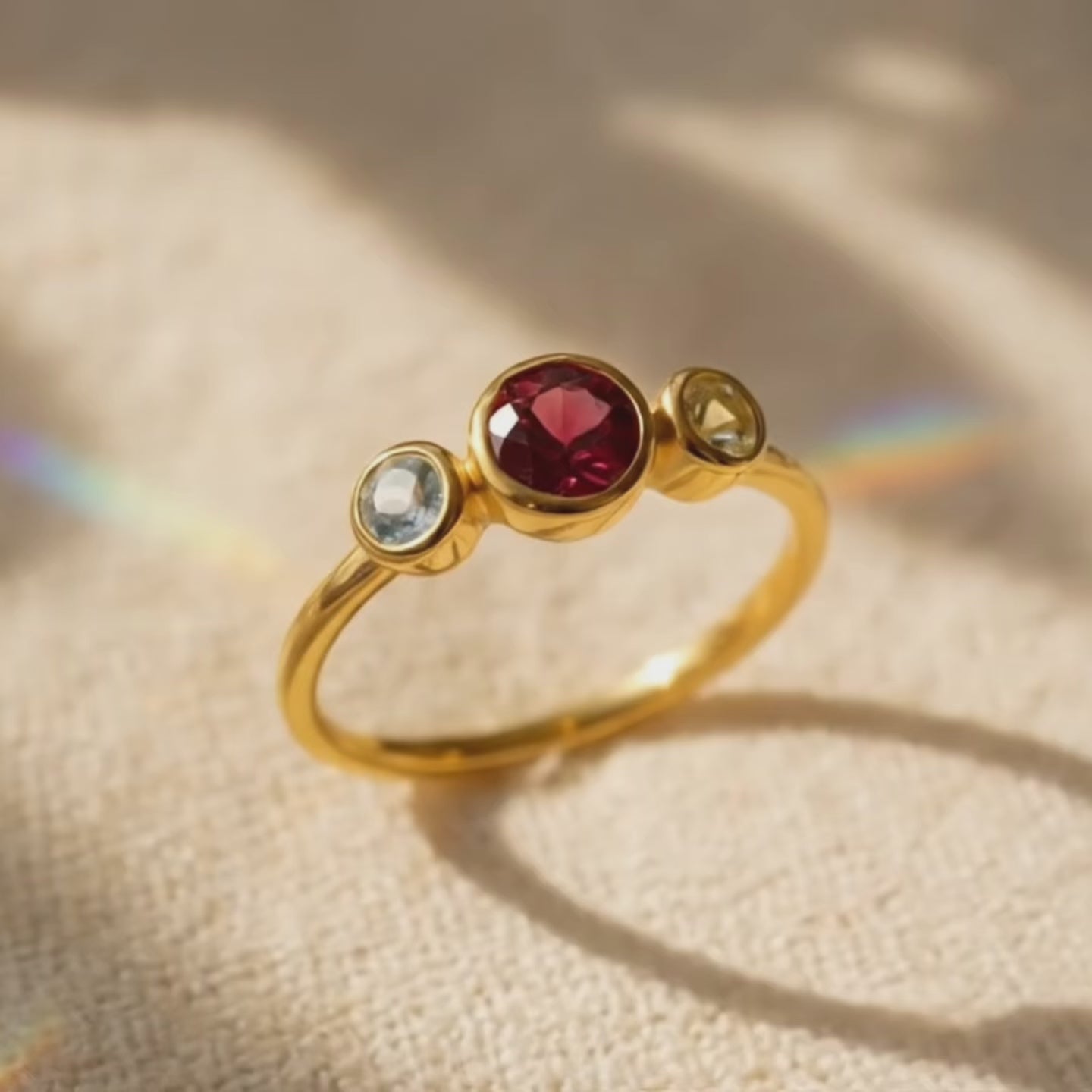 A video showcasing Custom mom birthstone ring with three stones, center stone for mother and two side stones for children