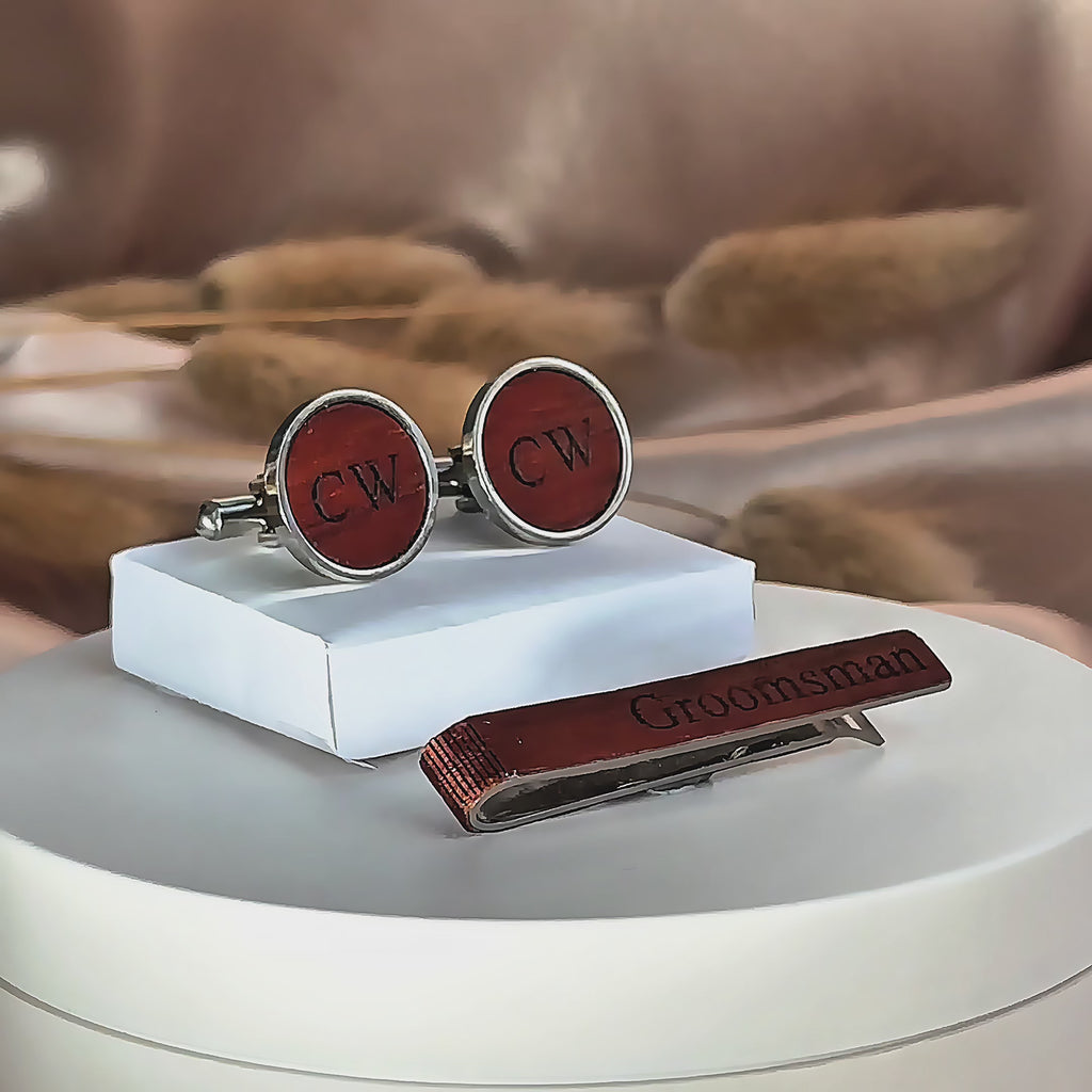 A pan over shows a variety of custom engraved rustic wooden tie clips and cuff links. A birch tie bar is turned front to back to show engravings on both sides. engraving options are monograms, photographs, names, initials, messages, and dates.  Matching cufflinks available. 6 wood finishes to choose from. Perfect for outdoor weddings.
