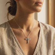 Video showcasing a delicate gold dragonfly necklace with filigree wings and a small red gemstone center, held gently between a woman's hands in warm natural sunlight. The clip highlights the pendant’s detailed craftsmanship, elegant chain, and feminine boho style, making it a meaningful nature-inspired jewelry gift for her, perfect for birthdays, anniversaries, or everyday wear.