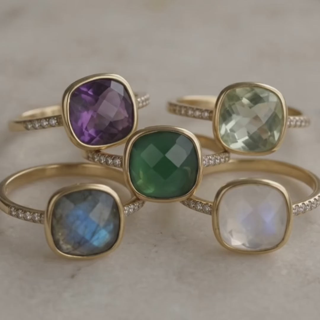 A video showcasing Natural Birthstone cushion bezel rings available in a variety on natural stones:  citrine, november birthstone ring and peridot August birthstone ring. Garnet, Purple Amethyst, Aquamarine, Clear Quartz, Emerald, Moonstone, Ruby, Sapphire, Fire Opal, Blue Topaz. Ready for gift giving in Danique Jewelry Branded Box. Available in Yellow or Rose gold or in Sterling Silver paved with tiny white topaz gemstones