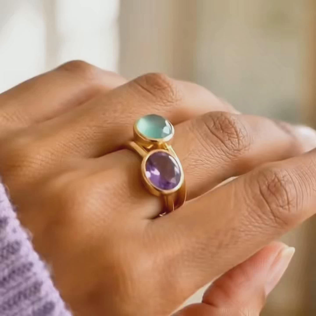 A video showcasing a combo of two oval bezel set stackable rings: Faceted moonstone and labradorite, citrine and peridot, blue topaz and sapphire, garnet and purple amethyst, emerald and green amethyst.
