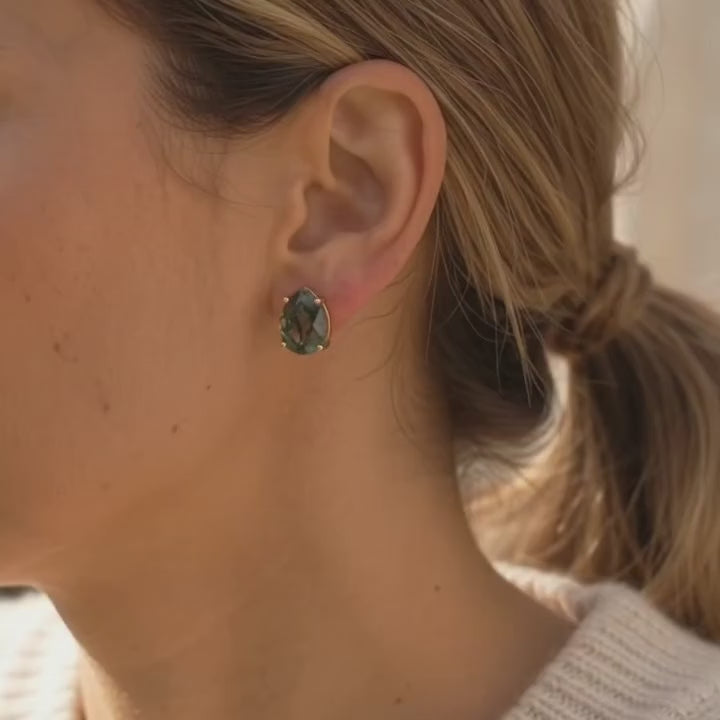 A video showcasing Natural moss agate teardrop stud earrings with faceted green gemstones in yellow gold prong settings
