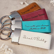 Assorted custom engraved leather keychains in brown, orange, red, and cream tones displayed on satin fabric, featuring personalized names, quotes, and phrases; handmade genuine leather accessories with silver hardware, unique teacher gift, graduation keepsake, or personalized bag charm; stylish engraved key rings perfect for coworkers, family, or friends, ideal for Father’s Day, Christmas, or anniversary gifting; handcrafted in Boston studio with premium materials and precision engraving.