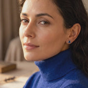 Video showcasing faceted triangle birthstone stud earrings in multiple gemstone colors, with close-up views of the minimalist bezel-set design and sparkling finish.