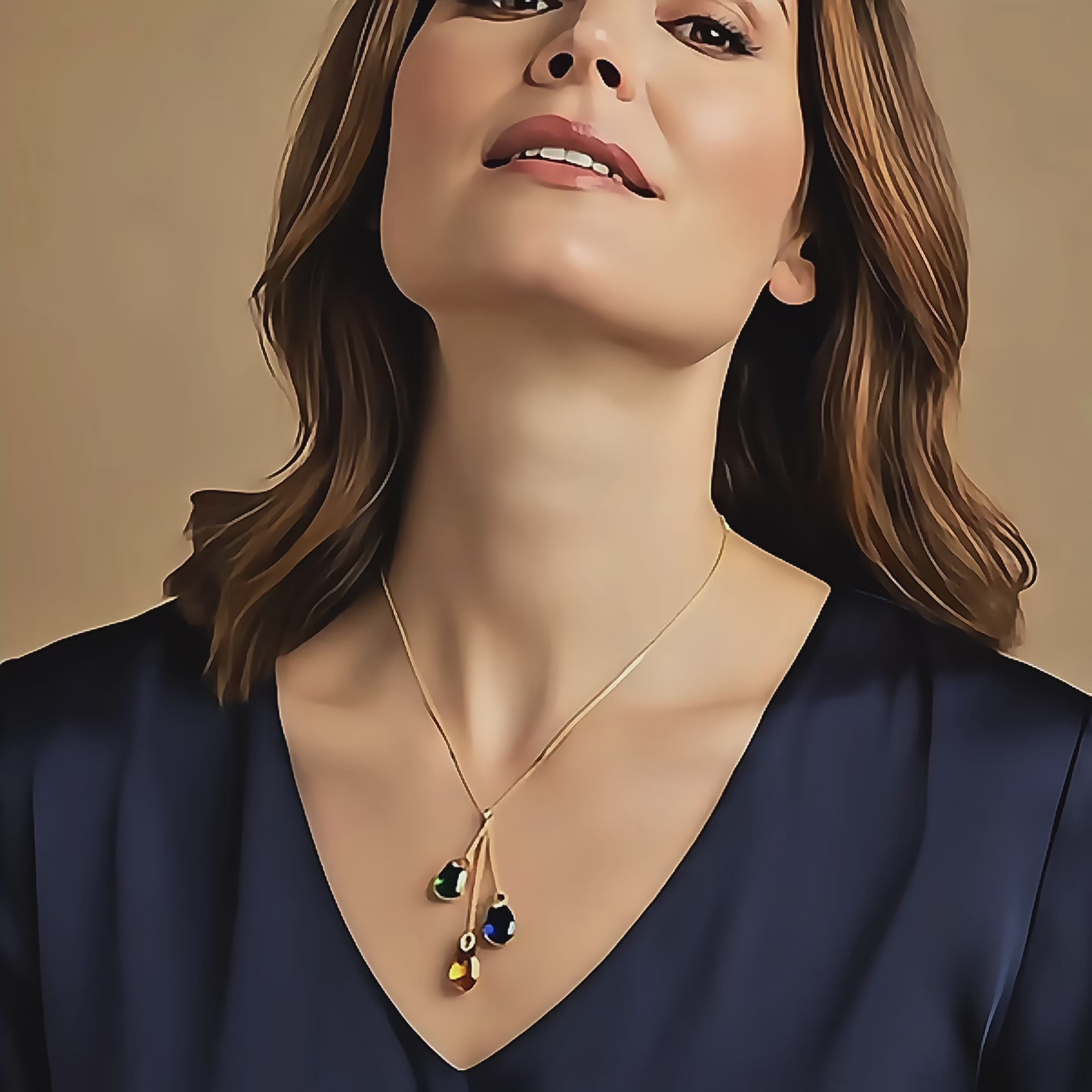 Video showcasing a personalized initial birthstone lariat necklace with two dangling teardrop gemstones on a delicate gold chain, featuring engraved heart initial charms above each stone. The video highlights the sparkling citrine and peridot birthstones as they catch the light, the elegant movement of the lariat design, and the customizable family, mom, and couples jewelry style—perfect for gifting and everyday wear.