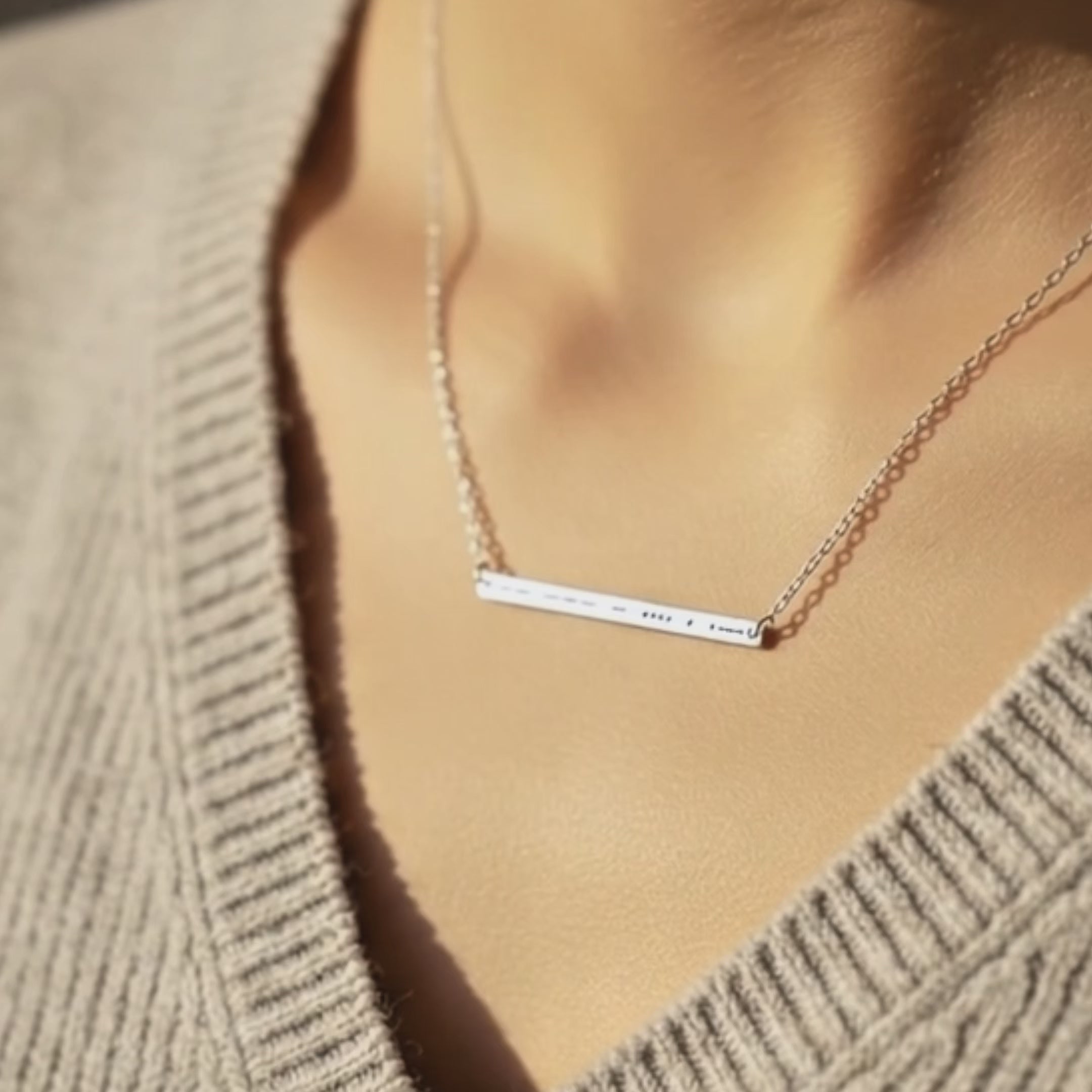 Morse code skinny bar necklace worn on model showcasing dainty minimalist jewelry style. Custom hidden message necklace engraved with personalized morse code word, available in silver, gold, or rose gold filled. Elegant everyday necklace designed for meaningful gifting.