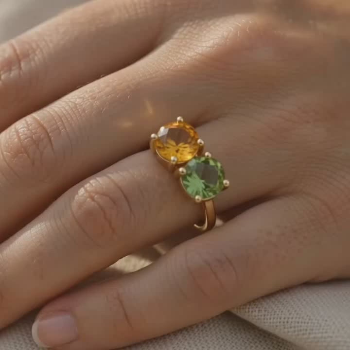 a video showcasing a Custom two birthstone ring with faceted clear quartz and ruby gemstones in yellow gold.