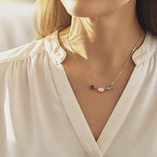 Video thumbnail showing cabochon birthstone necklace for mom with three bezel-set gemstones on gold chain; personalized family necklace with kids’ stones.