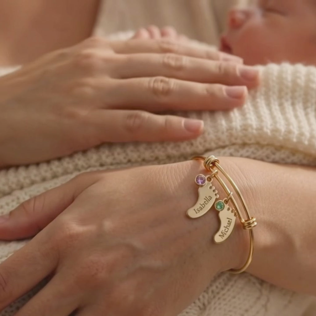 video showcasing a personalized footprint bangle bracelet with birthstone and name charms.