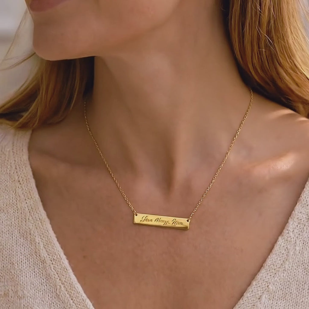 a Video showcasing a Custom engraved bar necklace in gold with handwriting message “Love Always Mom,” minimalist personalized necklace gift for mom, dainty gold bar pendant on delicate chain jewelry.