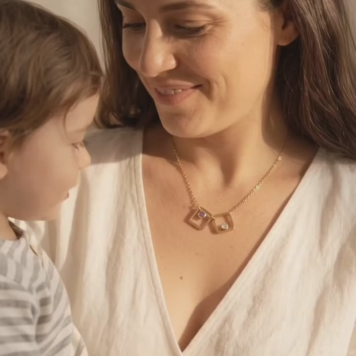 Video of model in white top wearing the gold filled square geometric necklace with kyanite and moonstone birthstones. 