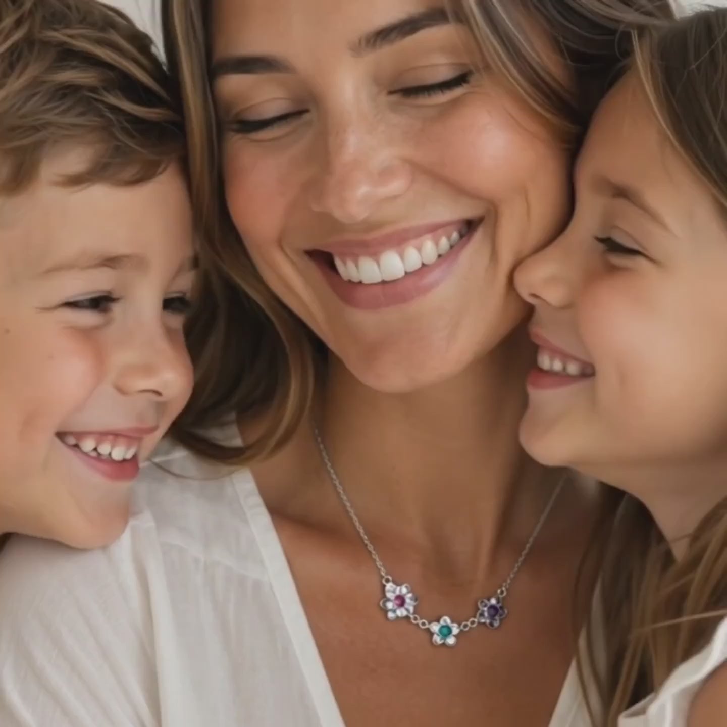 a video showcasing mother birthstone flower necklace with multiple small gemstone charms gold
