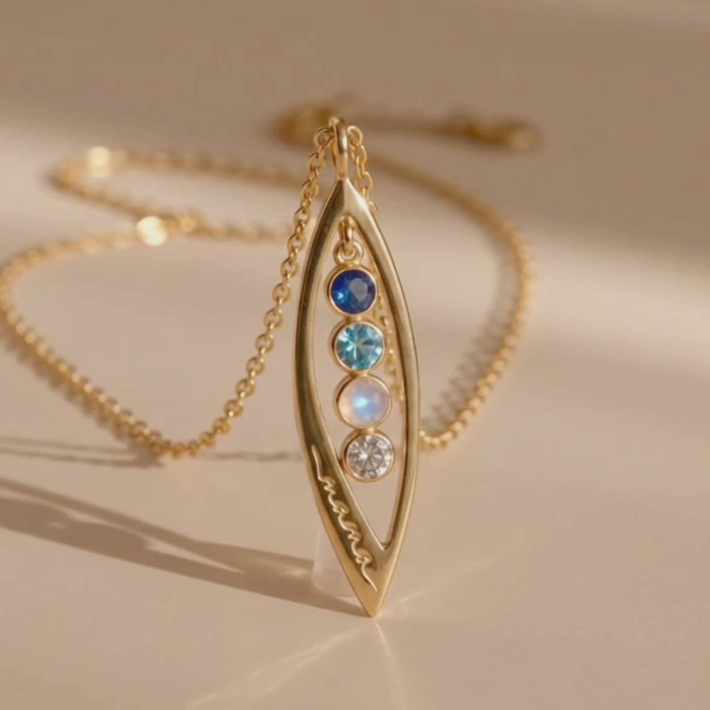 a video showcasing Custom marquise birthstone necklace with up to 5 tiny gemstones in gold, personalized family necklace for mom or loved one