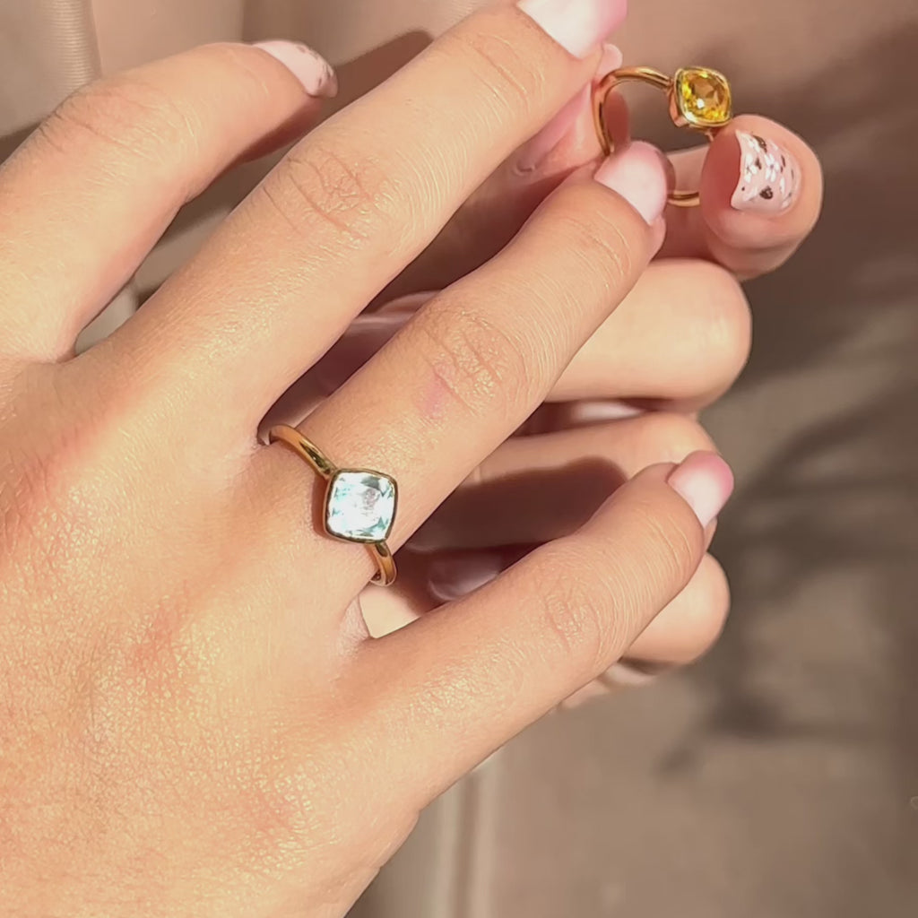 Video: dainty birthstone ring with diamond-shape (cushion) bezel on a slim 14k gold filled band; minimalist stacking ring for everyday wear. Available for all birth months—Garnet, Amethyst, Aquamarine, Diamond/White Topaz, Emerald, Alexandrite/Pearl, Ruby, Peridot, Sapphire, Opal/Tourmaline, Citrine/Topaz, Blue Topaz—a chic personalized gift.