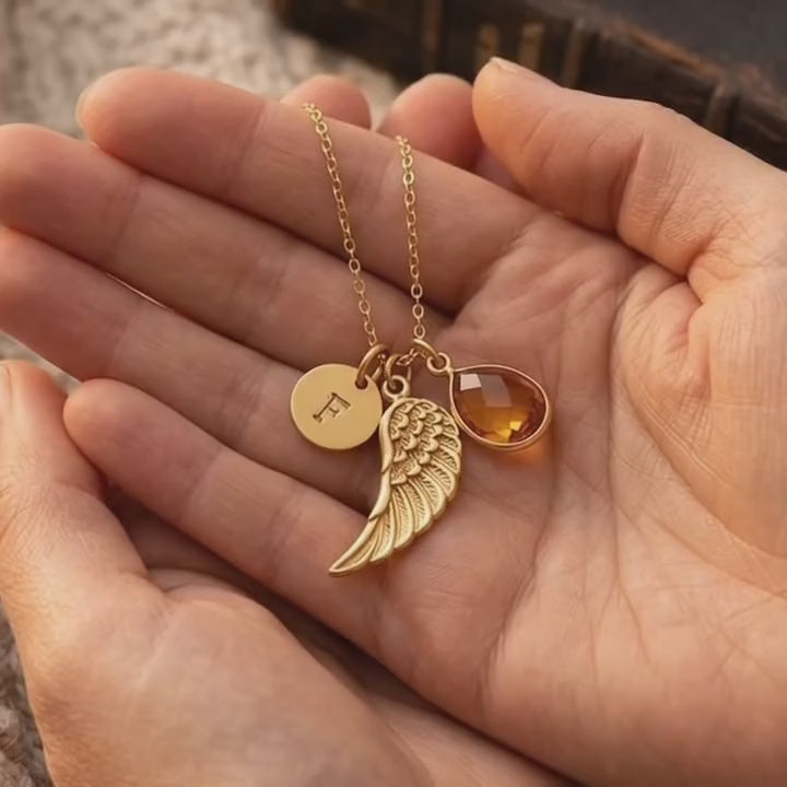 A video showcasing a Personalized angel wing necklace featuring a natural birthstone teardrop, engraved initial disk, and gold vermeil wing charm, a meaningful memorial jewelry piece and sympathy gift for women.