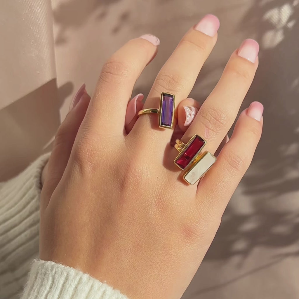 A video shows a stackable set of gemstone bar rings, personalized birthstone ring, unique birthstone ring, modern, minimalist, natural birthstone bar ring, birthday gift with birthstone, gemstone birthday gift for january, february, march, april, may, june, july, august, september, october, november, december, traditional birthstone gift