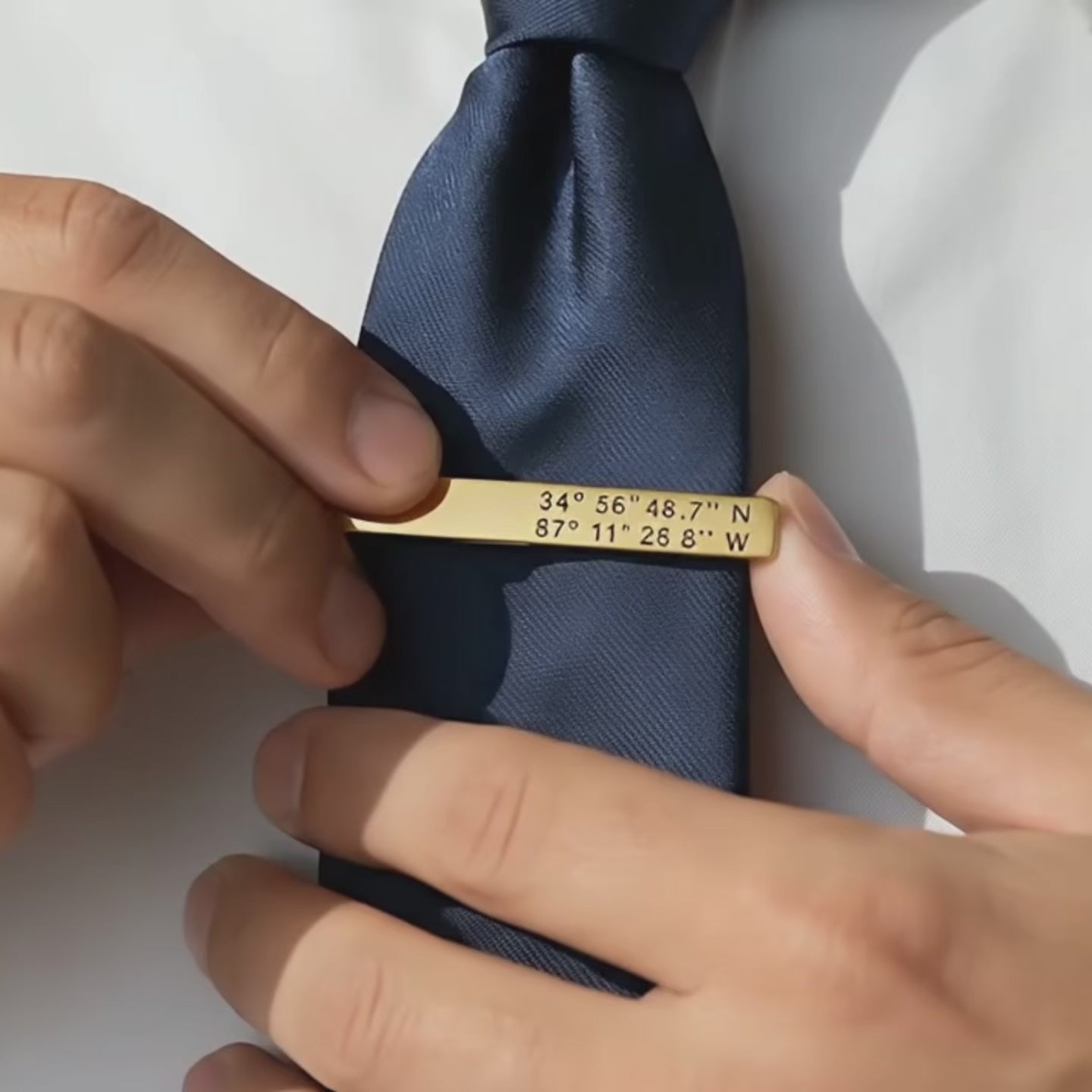 Video featuring a custom engraved metal tie clip handcrafted from high-quality stainless steel in silver, gold and black finishes. Personalized with initials, names, dates, or coordinates, this sleek men’s accessory makes a thoughtful gift for groomsmen, dad, husband, or anniversary.