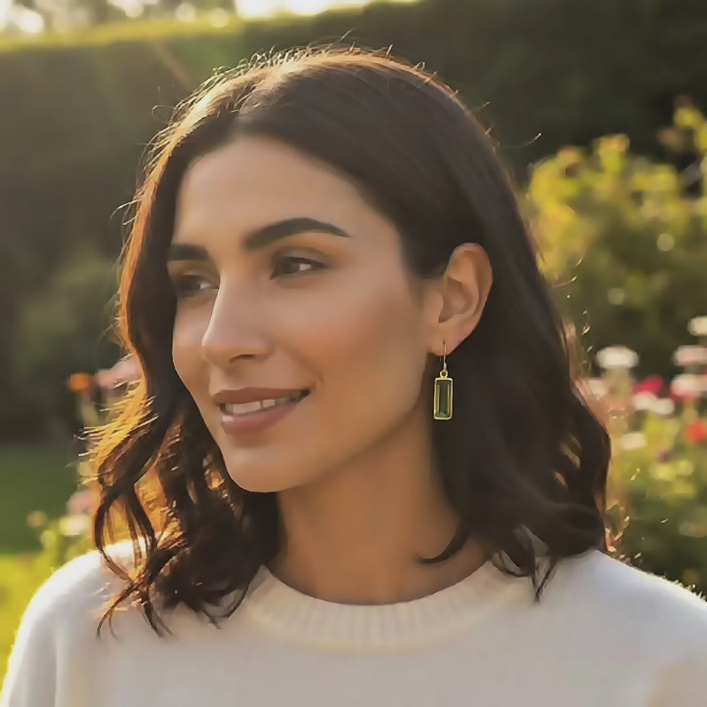 video showcasing delicate baguette cut birthstone earrings in gold vermeil, featuring an elongated rectangular gemstone that catches the light beautifully, shown worn for scale and movement; available in all birthstones for personalized gifting, including January garnet, February amethyst, March aquamarine, May emerald, July ruby, September sapphire, November citrine, and more; elegant minimalist design perfect for everyday wear, birthdays, anniversaries, and holiday gifts