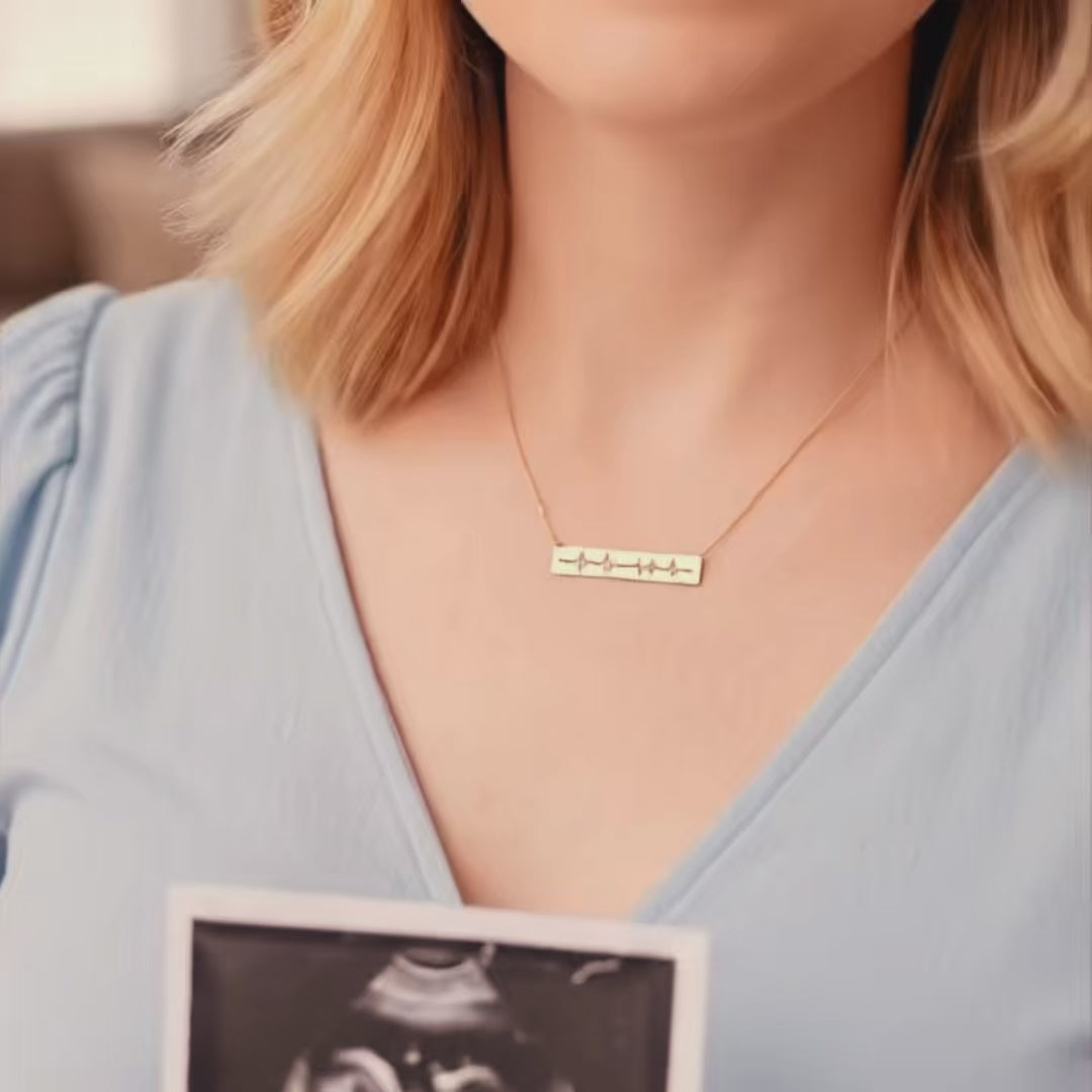 A video showing actual heartbeat sonogram engraved necklaces. Personalized heartbeat necklace, gift for new mom, push present for expecting mother, custom engraved heartbeat bar necklace, minimalist memorial memento, custom engraved bar style necklace, custom nameplate sonogram jewelry