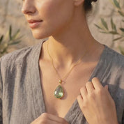 Video showcasing elegant natural gemstone birthstone necklaces in a variety of colors, featuring delicate teardrop pendants in gold and silver settings, shown on a model and in close-up. Available in all birthstones.