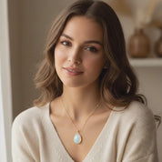 Opalite necklace video showcasing five pendant styles in gold including round, teardrop, oval and petite opalite pendants on delicate gold chains, iridescent opalite gemstone jewelry with soft blue and peach glow, minimalist gold opalite pendant necklace for women, dainty everyday birthstone style jewelry, customizable chain options gift for her, elegant layering necklace in warm sunlight, October inspired opal look necklace design