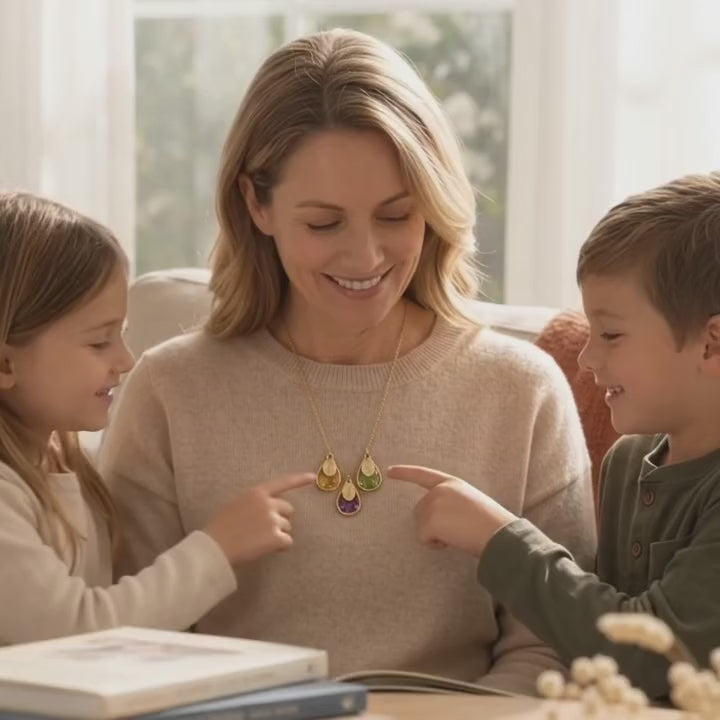 A video showcasing a Personalized family birthstone necklace with engraved names and three teardrop gemstones