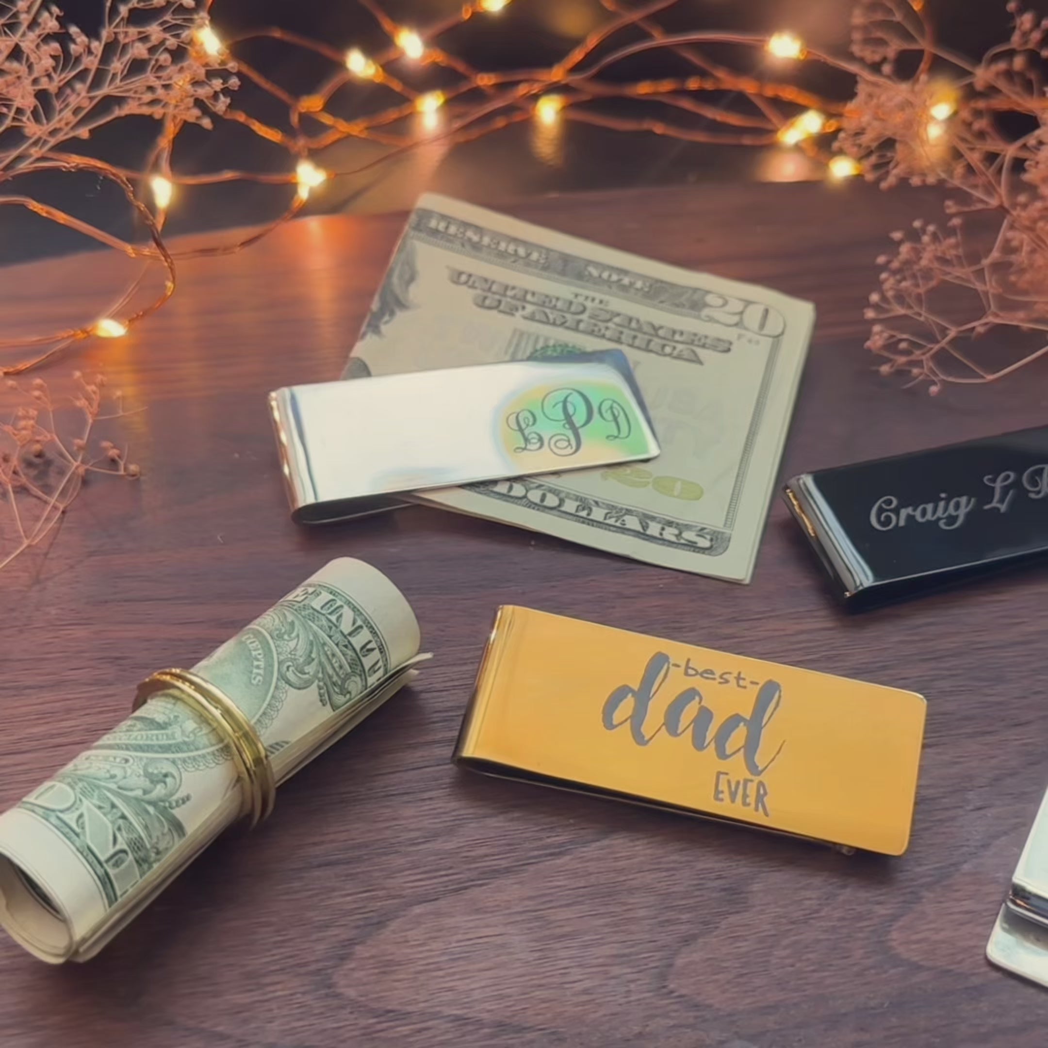 A person holds a gold stainless steel money clip monogrammed on the front. These money clips can be made in one of 3 steel finishes - silver gold or black. Engravings are applied via laser engraving machine and last a lifetime. Perfect as Father's Day gifts, gifts for Dad, Grandpa or Brother. Money clips are hand crafted with care and are the ideal traditional gift to last a lifetime or even through several generations with the proper care. Custom images can be engraved as well as plain text.