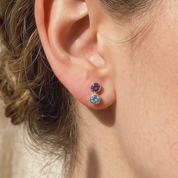 A video showcasing Custom birthstone bar stud earrings with one, two, and three gemstone options in 18K yellow gold, shown on soft fabric with natural shadows for a dainty personalized jewelry look.