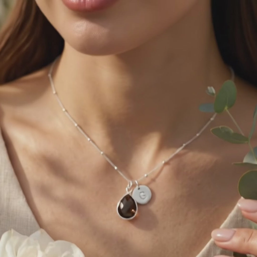 video showcasing the Birthstone initial necklace with teardrop gemstone and letter charm