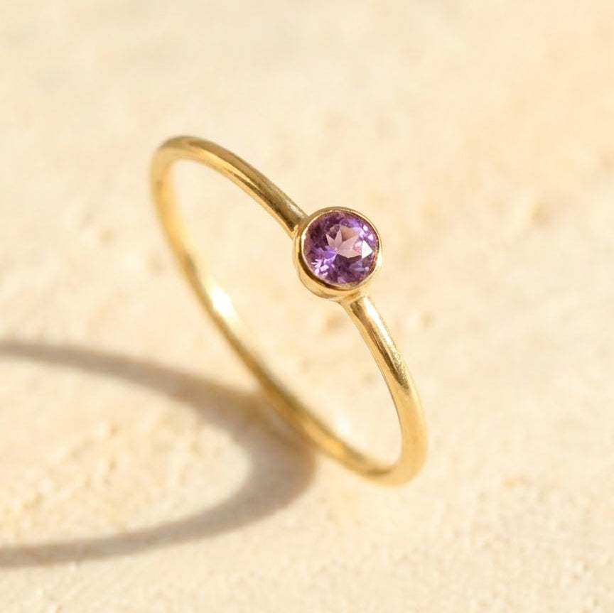 Dainty amethyst bezel ring in gold, February birthstone minimalist stacking ring close-up