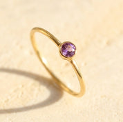 Dainty amethyst bezel ring in gold, February birthstone minimalist stacking ring close-up