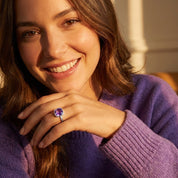 Woman wearing gold amethyst ring, cushion cut purple gemstone jewelry, February birthstone ring for women, modern minimalist statement ring style