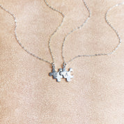 Silver puzzle charm necklace with A initial on beige background. sterling silver or vermeil gold, each charm features a single engraved initial. Whether it’s for your other half, your lifelong best friend, or a bond between mother and child, this necklace makes a meaningful gift for Christmas, Mother’s Day, or Valentine’s Day. layering necklace, puzzle piece, bff jewelry, couples jewelry, bff necklace, couples necklace