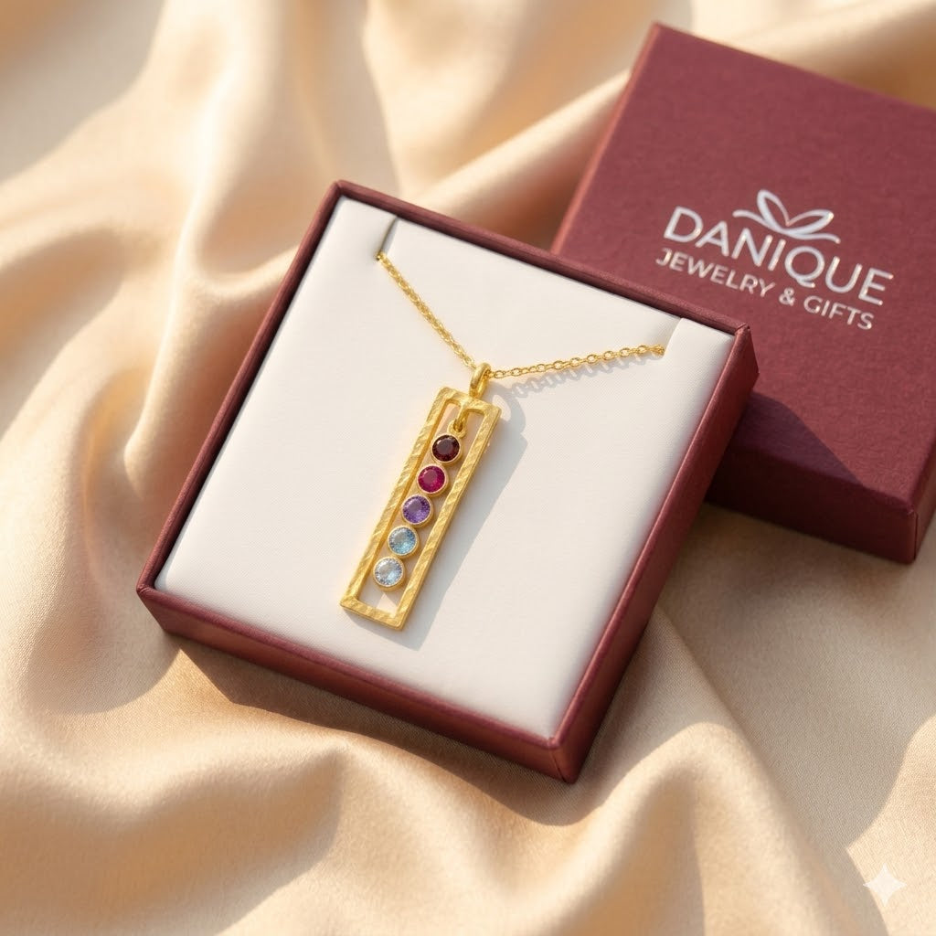 Gold birthstone bar necklace displayed in a Danique Jewelry box, personalized with five stones for children or grandchildren.